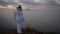 An astronaut in spacesuit explores an unknown planet. Valley with fog in the background