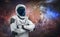 Astronaut stand on space background with stars. Spaceman in spacesuit. Cosmic sci-fi wallpaper