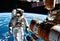 astronauts performing spacewalk in deep space, repair work on station in space, work in space, advanced technologies,