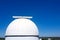 Astronomical observatory dome in blue sky