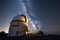 astronomical observatory, with telescopes pointing to the night sky and stars