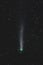 Astrophoto of periodic comet 12P Pons Brooks in the night sky. Green nucleus and tail of ion, dust and