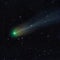 Astrophoto of periodic comet 12P Pons Brooks in the night sky. Green nucleus and tail of ion, dust and
