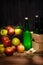 Asturian cider and apples on black background.