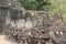 Asuras demons statues in a row at the Bayon Temple entrance gate