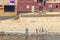 Aswan, Egypt - September 13, 2018: Children waving to Nile Cruise tourists next to the Nile River, southern Egypt