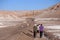 Atacama, Chilean Andes highlands. People walking in a dusty road in the middle of desert