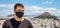 Athens Acropolis, Greece coronavirus days. Young man wearing protective face mask on cityscape and blue sky background