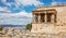Athens, Greece. Erechtheion with Cariatides Porch on Acropolis hill, blue sky background
