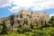 ATHENS, GREECE - JULY 18, 2018: close up view of famous Acropolis with people who visit the Parthenon, Erechtheum, Propylaea