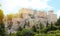 ATHENS, GREECE - JULY 18, 2018: close up view of famous Acropolis with people who visit the Parthenon, Erechtheum, Propylaea and