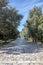 Athens, Greece. People walk on a cobblestone pathway at Filopappou hill