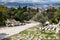 Athens Greece, Roman agora. Ancient ruins, marble columns parts stacked on the ground, Athens cityscape and cloudy sky background