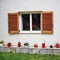 Athens Greece, window with wooden shutters and flowerpots