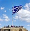 ATHENS, GREECE â€“ 1 APRIL 2019: Huge Greece flag on the top of Actopolis Hill