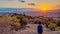 Athens - Tourist man watching the sunset over city of Athens seen from Filopappou Hill (hill of muses), Athens, Attica, Greece