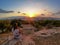 Athens - Tourist woman watching the sunset over city of Athens seen from Filopappou Hill (hill of muses), Athens, Attica, Greece