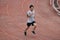 Athlete Asian man running on racetrack in stadium . Healthy active lifestyle concept.