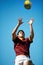Athlete, ball and rugby player catching in training on a blue sky background for sport. Professional male person