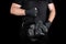 athlete in black clothes holds very old vintage leather black boxing gloves