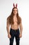 Athlete bodybuilder shirtless with long hair posing with a rabbit-like ears
