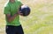 Athlete catching a medicine ball on a grass field