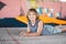 Athlete Caucasian boy sitting on trampoline after training. child is engaged in trampolining on professional trampoline outside.