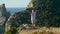 Athlete concentrating yoga asana at beautiful sea cliff edge. Focused man making