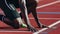 Athlete crouched, preparing for the race\\\'s start, embodying focus and determination. Ai Generated