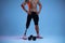 Athlete with disabilities or amputee  on blue studio background. Professional male sportsman with leg prosthesis