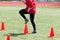 Athlete doing running drills over cones