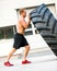 Athlete Doing Tire-Flip Exercise Outside Gym