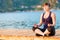 Athlete doing yoga on the pier