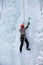 The athlete is engaged in winter mountaineering. Ice Wall Climbing