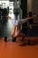 Athlete Exercising Handstand Push-Ups On Barbell In Gym