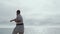 Athlete exercising karate standing ocean beach. Judo fighter practicing attack.