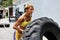 Athlete female working out with a huge tire, turning and flippin