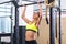 Athlete fit woman performing pull ups in a bar exercising at gym.