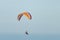 Athlete flying parachute by the sea