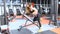 Athlete girl in sportswear working out and training her arms and shoulders in gym.