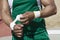 Athlete In Green Sportswear Taping Wrist