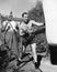 Athlete with his trainer working on a punching bag