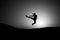 Athlete jump high with energy. Sportsman silhouette on sunset sky. Man training on natural landscape. Workout in summer