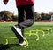 Athlete jumping on one leg over yellow mini hurdles