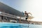 Athlete jumping over an hurdle on running track