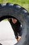 Athlete Lifting Large Tractor Tire On Street