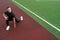 The athlete makes lunges, exercise to warm up before training. Male bodybuilder trains on sports ground