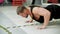 Athlete man pushing up on floor in fitness club. Bearded sportsman training push up exercise on floor in gym club. Male