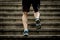 Athlete man with strong leg muscles training and running urban city staircase in sport fitness and healthy lifestyle concept