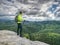 Athlete man tourist hiking mountain trail, walking on rock